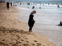 Palestinians are gathering on the beach in Nuseirat in the central Gaza Strip on June 27, 2024, amid ongoing cross-border tensions as fighti...