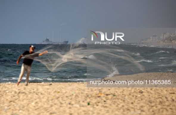 A ship is being pictured off the coast of Gaza near a temporary floating pier anchored by the United States to boost aid deliveries, as seen...