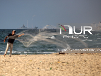 A ship is being pictured off the coast of Gaza near a temporary floating pier anchored by the United States to boost aid deliveries, as seen...