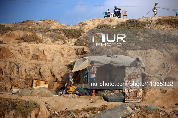 Palestinians are gathering on the beach in Nuseirat in the central Gaza Strip on June 27, 2024, amid ongoing cross-border tensions as fighti...