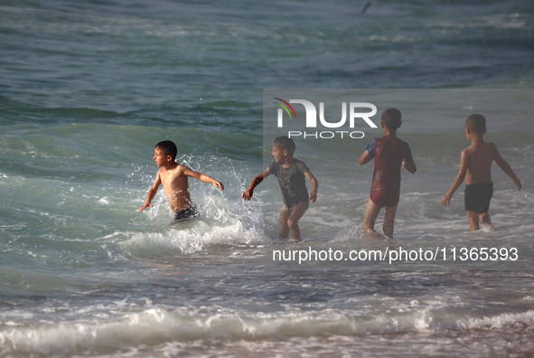 Palestinians are gathering on the beach in Nuseirat in the central Gaza Strip on June 27, 2024, amid ongoing cross-border tensions as fighti...