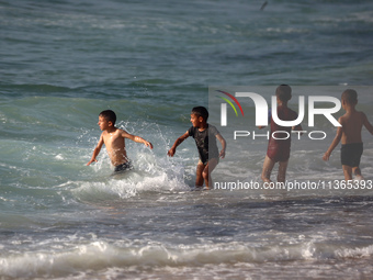 Palestinians are gathering on the beach in Nuseirat in the central Gaza Strip on June 27, 2024, amid ongoing cross-border tensions as fighti...