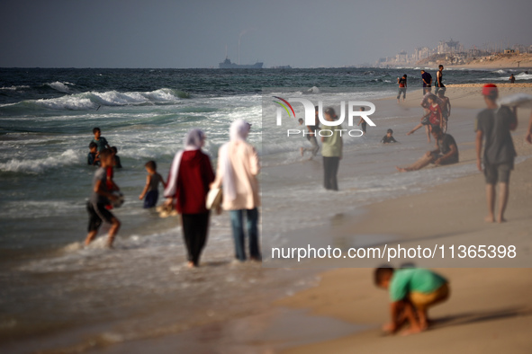 Palestinians are gathering on the beach in Nuseirat in the central Gaza Strip on June 27, 2024, amid ongoing cross-border tensions as fighti...