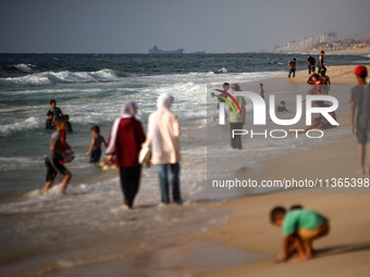 Palestinians are gathering on the beach in Nuseirat in the central Gaza Strip on June 27, 2024, amid ongoing cross-border tensions as fighti...