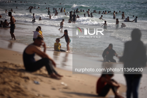 Palestinians are gathering on the beach in Nuseirat in the central Gaza Strip on June 27, 2024, amid ongoing cross-border tensions as fighti...