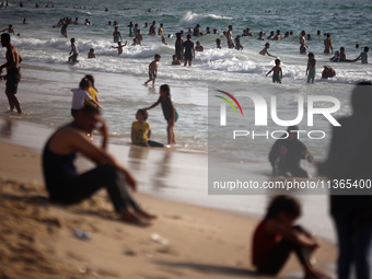 Palestinians are gathering on the beach in Nuseirat in the central Gaza Strip on June 27, 2024, amid ongoing cross-border tensions as fighti...