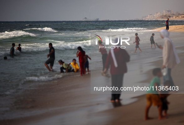 A ship is being pictured off the coast of Gaza near a temporary floating pier anchored by the United States to boost aid deliveries, as seen...