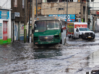 A public transport driver is crossing a flooded street in the municipality of Nezahualcoyotl due to the heavy rains recorded yesterday in Me...