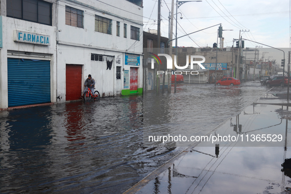 A flooded street is being seen in the municipality of Nezahualcoyotl due to the heavy rains recorded yesterday in Mexico City, Mexico, on Ju...