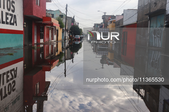 A flooded street is being seen in the municipality of Nezahualcoyotl due to the heavy rains recorded yesterday in Mexico City, Mexico, on Ju...