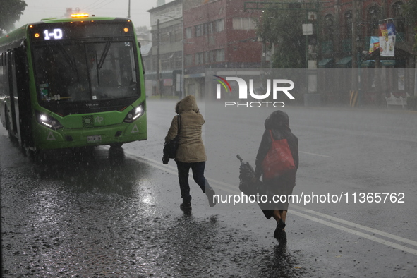 People are running under heavy rains on the Calzada Ermita south of the city, due to Tropical Wave Number 5, which is hitting Mexico. Due to...