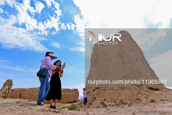 Staff members are conducting on-site investigation and data collection at a beacon tower in the Xitun section of Han Great Wall in Zhangye,...