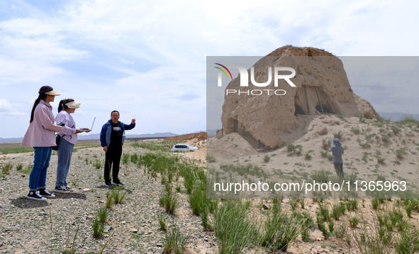 Staff members are conducting site investigation and data collection at the JinshanZi section of the Ming Great Wall in Zhangye, China, on Ju...