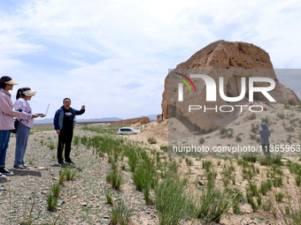 Staff members are conducting site investigation and data collection at the JinshanZi section of the Ming Great Wall in Zhangye, China, on Ju...