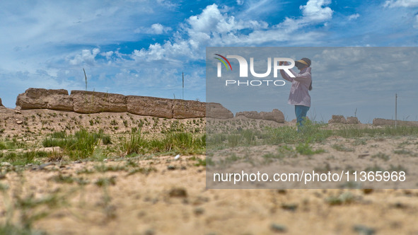 Staff members are conducting site investigation and data collection at the JinshanZi section of the Ming Great Wall in Zhangye, China, on Ju...