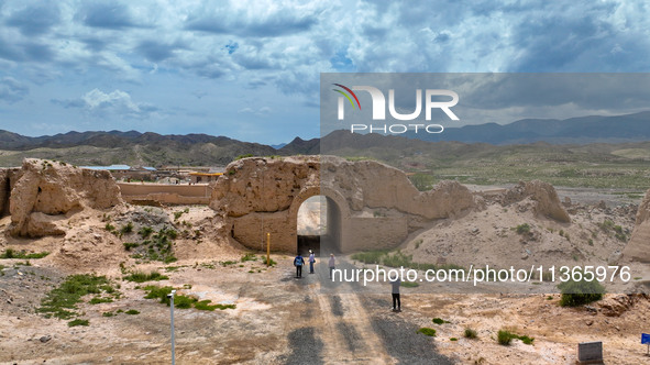 Workers are carrying out site investigation and data collection at the ancient city section of Xiakou in Zhangye, China, on June 27, 2024. I...