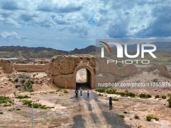 Workers are carrying out site investigation and data collection at the ancient city section of Xiakou in Zhangye, China, on June 27, 2024. I...