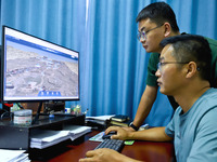 Staff members of the Han Ming Great Wall Protection and Research Center are using a 3D digital platform on a computer to measure the Great W...