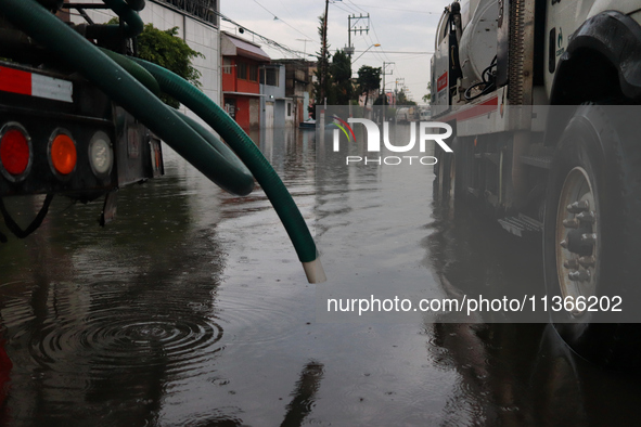 A dewatering truck is draining the water after the heavy rains that hit Mexico. Vicente Villada Avenue in the Municipality of Nezahualcoyotl...