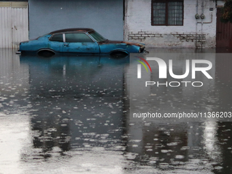 A car is being seen submerged above the tires due to the heavy rains that are hitting Mexico. Vicente Villada Avenue in the Municipality of...