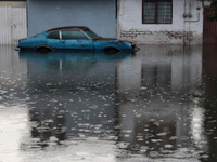 A car is being seen submerged above the tires due to the heavy rains that are hitting Mexico. Vicente Villada Avenue in the Municipality of...