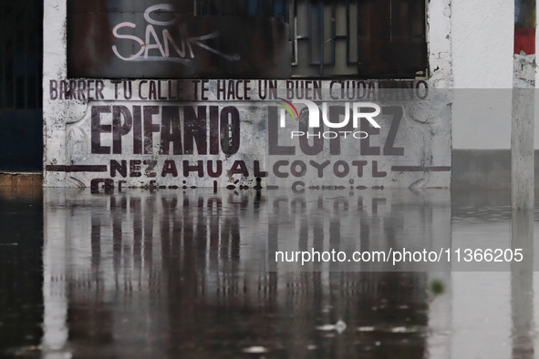 A fence is being seen submerged after the heavy rains that are hitting Mexico. Vicente Villada Avenue in the Municipality of Nezahualcoyotl...