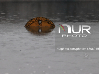 A road sign is being seen submerged due to the heavy rains that are hitting Mexico. Vicente Villada Avenue in the Municipality of Nezahualco...