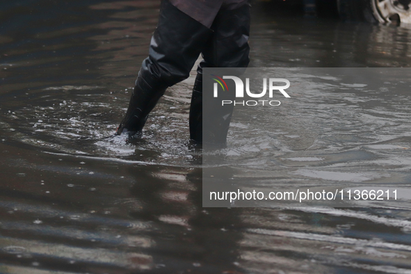 A dewatering worker is draining the water after the heavy rains that hit Mexico. Vicente Villada Avenue in the Municipality of Nezahualcoyot...