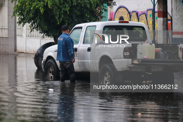 A dewatering worker is draining the water after the heavy rains that hit Mexico. Vicente Villada Avenue in the Municipality of Nezahualcoyot...