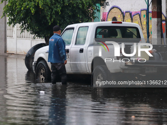 A dewatering worker is draining the water after the heavy rains that hit Mexico. Vicente Villada Avenue in the Municipality of Nezahualcoyot...