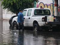 A dewatering worker is draining the water after the heavy rains that hit Mexico. Vicente Villada Avenue in the Municipality of Nezahualcoyot...