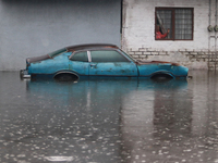 An old woman is looking at a car submerged due to the heavy rains that are hitting Mexico. Vicente Villada Avenue in the Municipality of Nez...