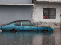 An old woman is looking at a car submerged due to the heavy rains that are hitting Mexico. Vicente Villada Avenue in the Municipality of Nez...