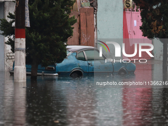 A car is being seen submerged above the tires due to the heavy rains that are hitting Mexico. Vicente Villada Avenue in the Municipality of...