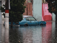 A car is being seen submerged above the tires due to the heavy rains that are hitting Mexico. Vicente Villada Avenue in the Municipality of...