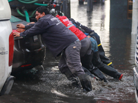 Municipality workers are pushing a stranded vehicle due to the heavy rains that are hitting Mexico. Vicente Villada Avenue in the Municipali...