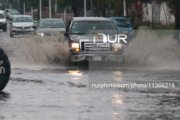 Drivers are trying to cross the Vicente Villada Avenue, which is flooded due to the heavy rains that are hitting Mexico. Vicente Villada Ave...