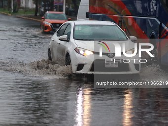 Drivers are trying to cross the Vicente Villada Avenue, which is flooded due to the heavy rains that are hitting Mexico. Vicente Villada Ave...