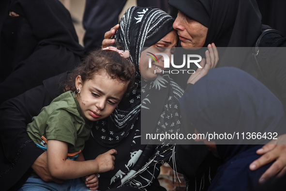 Mourners are reacting during the funeral of Palestinians killed in Israeli strikes, amid the Israel-Hamas conflict, at Al-Aqsa hospital in D...