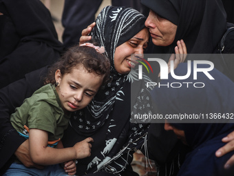 Mourners are reacting during the funeral of Palestinians killed in Israeli strikes, amid the Israel-Hamas conflict, at Al-Aqsa hospital in D...