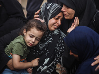 Mourners are reacting during the funeral of Palestinians killed in Israeli strikes, amid the Israel-Hamas conflict, at Al-Aqsa hospital in D...