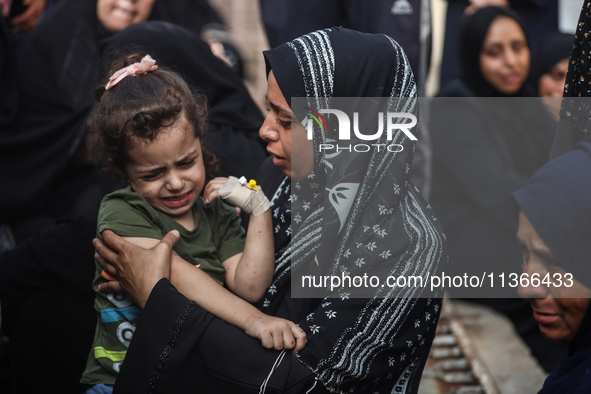 Mourners are reacting during the funeral of Palestinians killed in Israeli strikes, amid the Israel-Hamas conflict, at Al-Aqsa hospital in D...