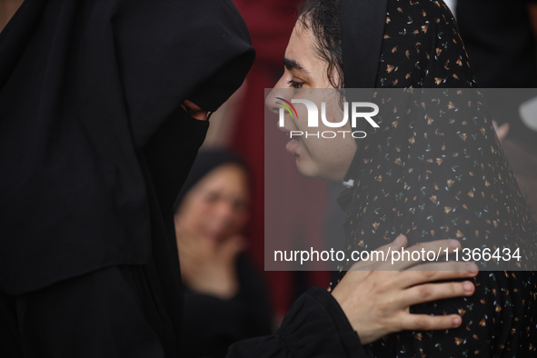 A mourner is reacting during the funeral of Palestinians killed in Israeli strikes, amid the Israel-Hamas conflict, at Al-Aqsa hospital in D...