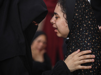 A mourner is reacting during the funeral of Palestinians killed in Israeli strikes, amid the Israel-Hamas conflict, at Al-Aqsa hospital in D...