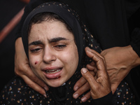 A mourner is reacting during the funeral of Palestinians killed in Israeli strikes, amid the Israel-Hamas conflict, at Al-Aqsa hospital in D...