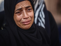 A mourner is reacting during the funeral of Palestinians killed in Israeli strikes, amid the Israel-Hamas conflict, at Al-Aqsa hospital in D...