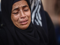 A mourner is reacting during the funeral of Palestinians killed in Israeli strikes, amid the Israel-Hamas conflict, at Al-Aqsa hospital in D...