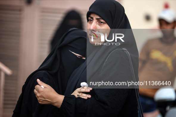 Mourners are reacting during the funeral of Palestinians killed in Israeli strikes, amid the Israel-Hamas conflict, at Al-Aqsa hospital in D...