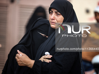 Mourners are reacting during the funeral of Palestinians killed in Israeli strikes, amid the Israel-Hamas conflict, at Al-Aqsa hospital in D...