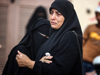 Mourners are reacting during the funeral of Palestinians killed in Israeli strikes, amid the Israel-Hamas conflict, at Al-Aqsa hospital in D...